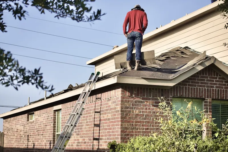 Professional roofer working on a residential roof in Lexington